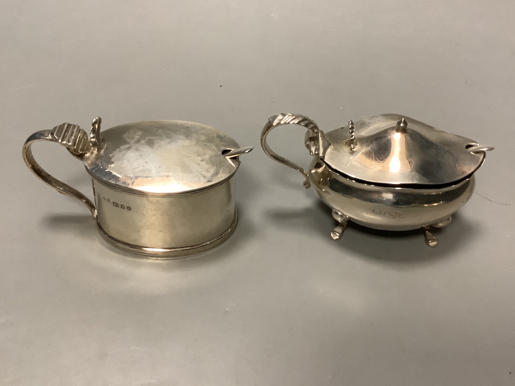 A pair of George V silver pepperettes, a pair of silver salts, and two silver mustard pots.